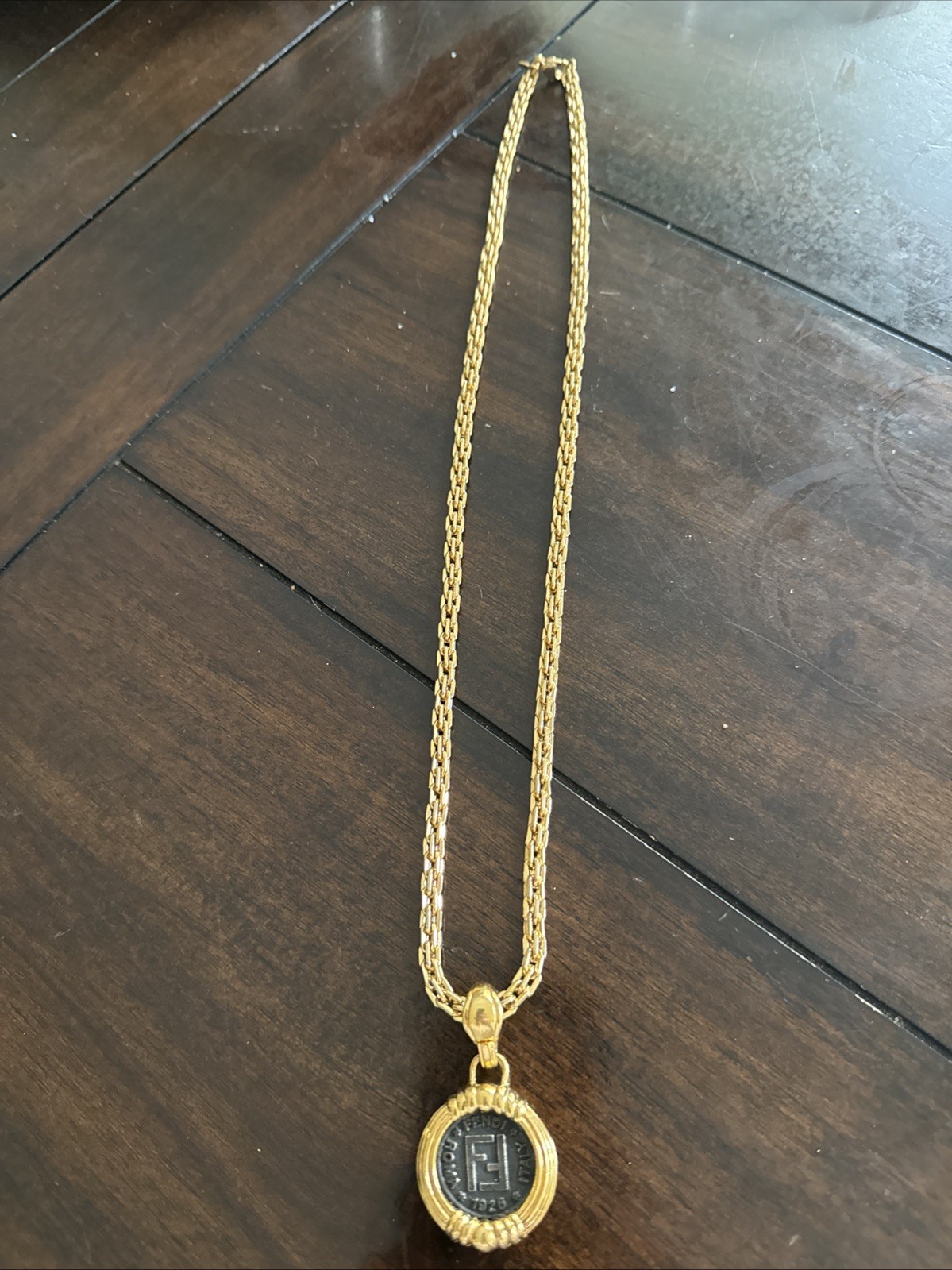 This is a vintage Fendi Coin Pendant Necklace featuring a detailed antiqued coin