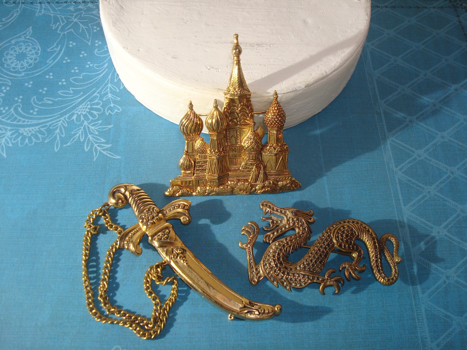 VINTAGE LOT(3) BROOCHES,CHINESE DRAGON,J.J RUSSIAN CATHEDRAL,M/EAST DAGGER PERF.