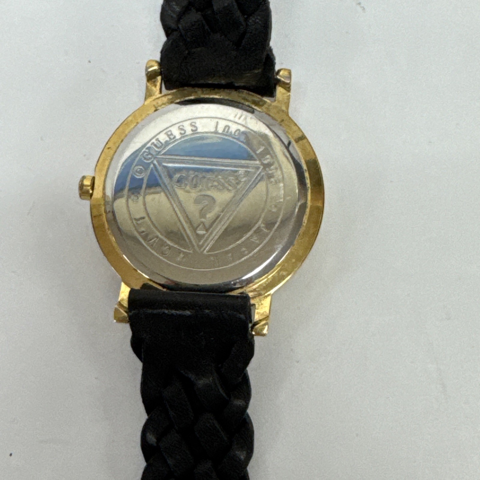Vtg Guess watch gold-tone & raised 3D numbers and a black braided leather band.