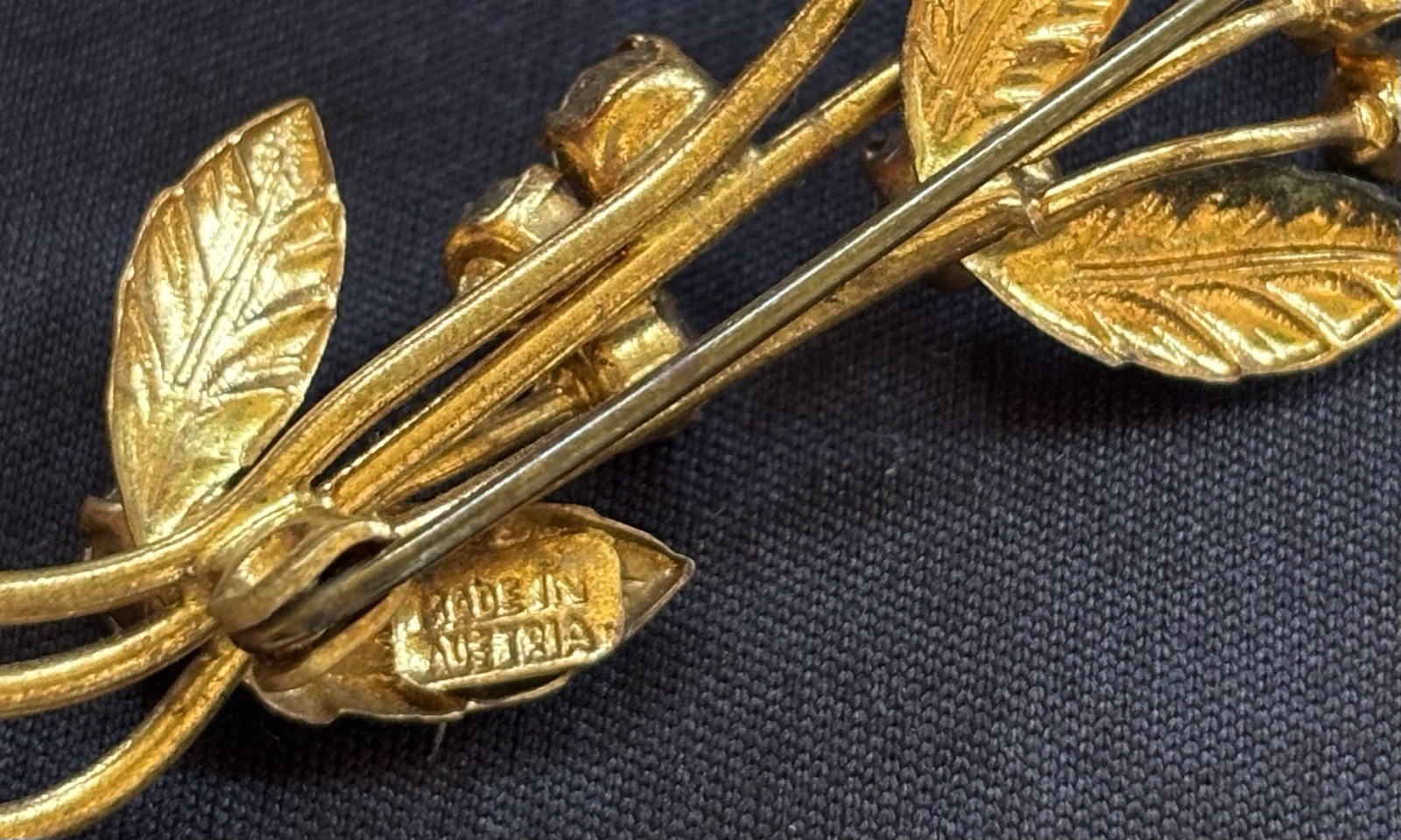 Lot of 3 gold tone floral brooches one signed