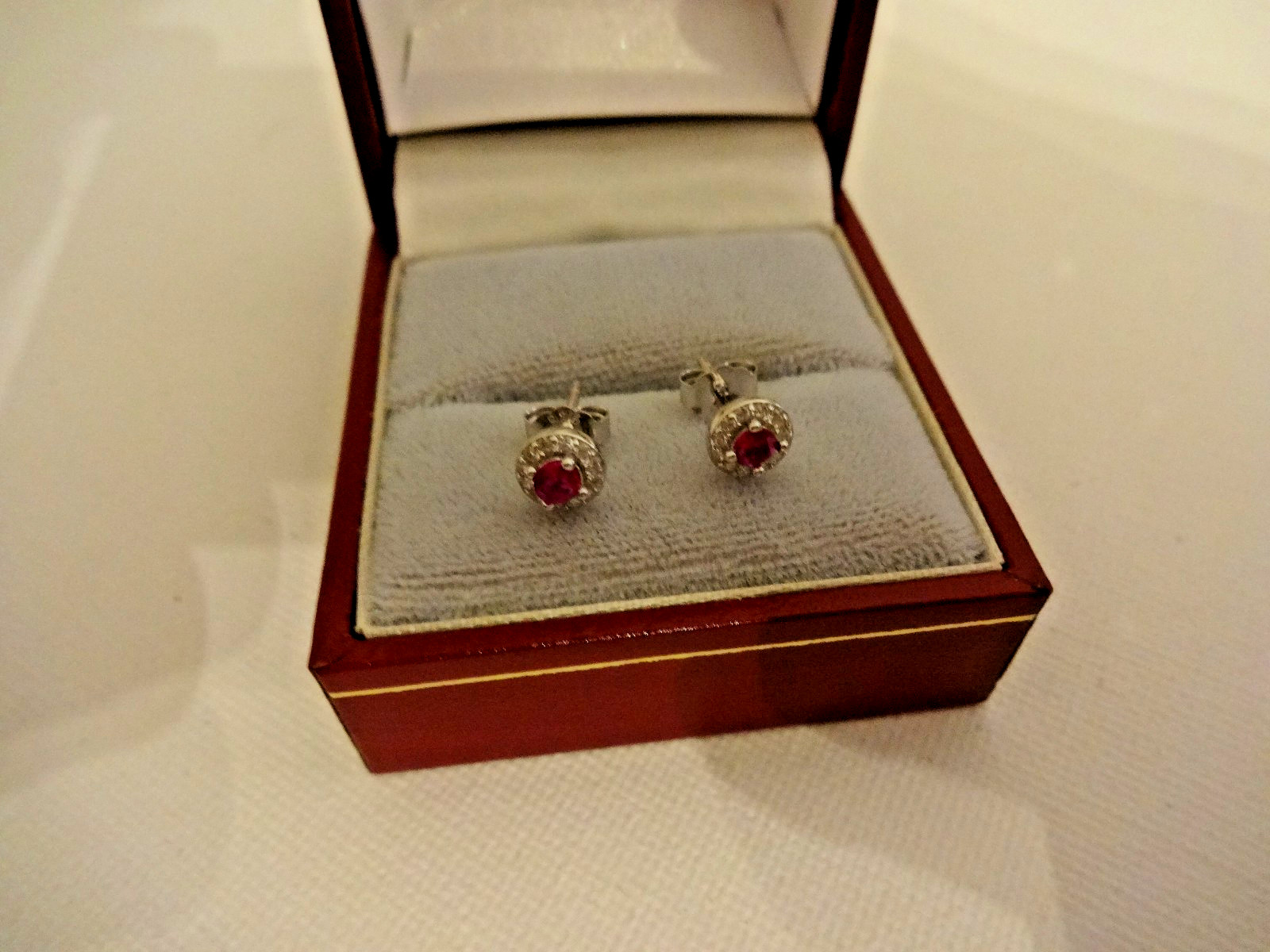 Created Ruby and diamond halo stud earrings in sterling silver