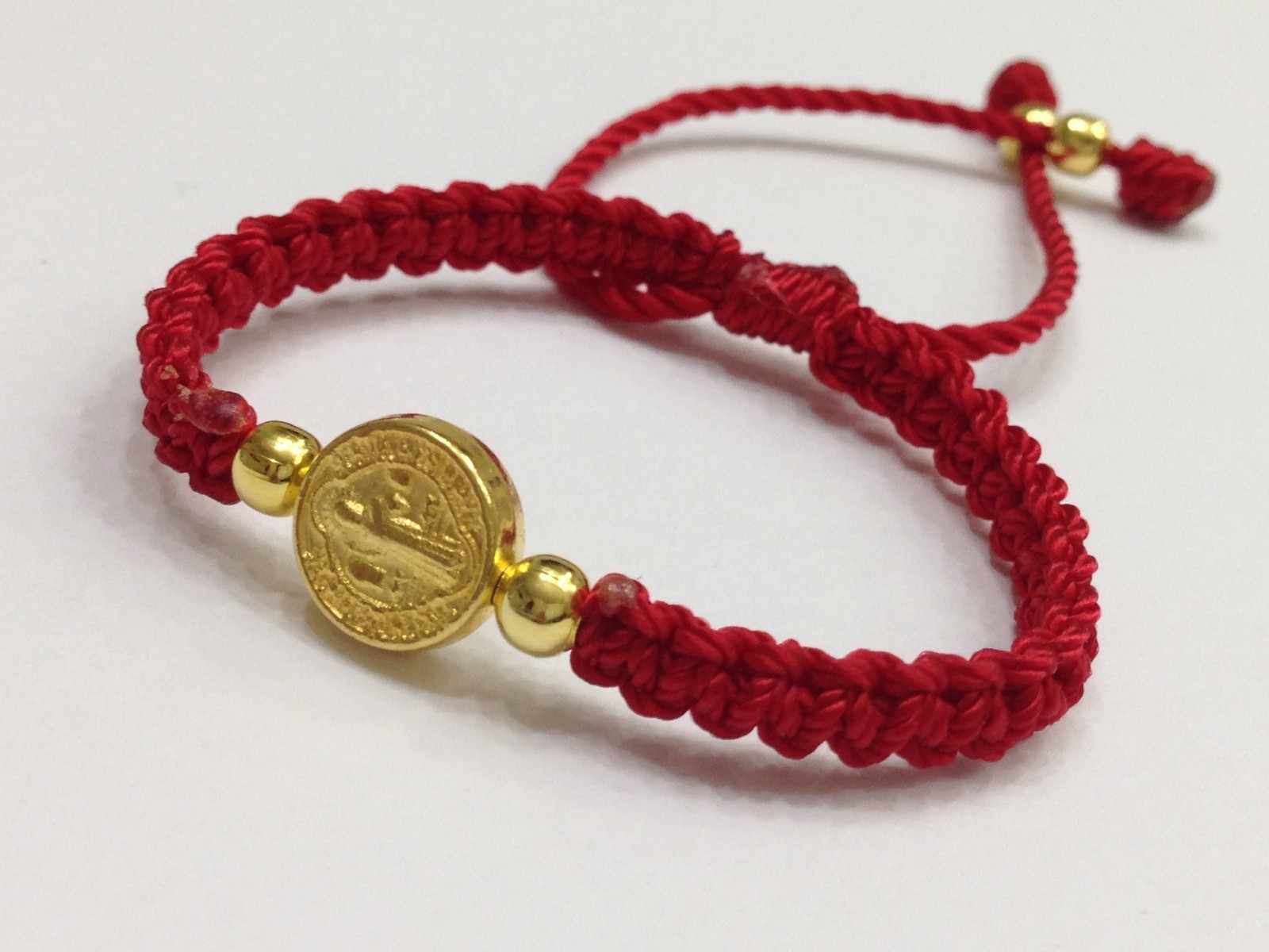St. Benedict bracelet evil eye protects the hand-woven with red thread. macrame
