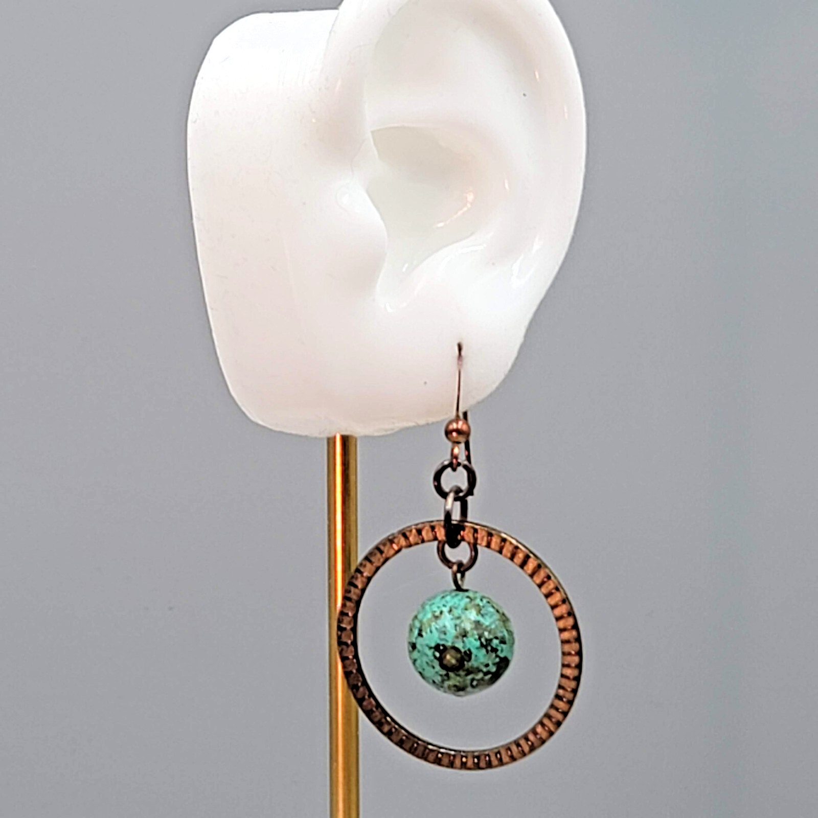 Bronze tone Dangle Pierced Earrings Green Bead Center Dangle 1.5″