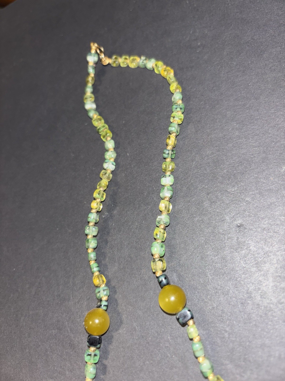 multi-stone beaded necklace featuring various green and yellow beads