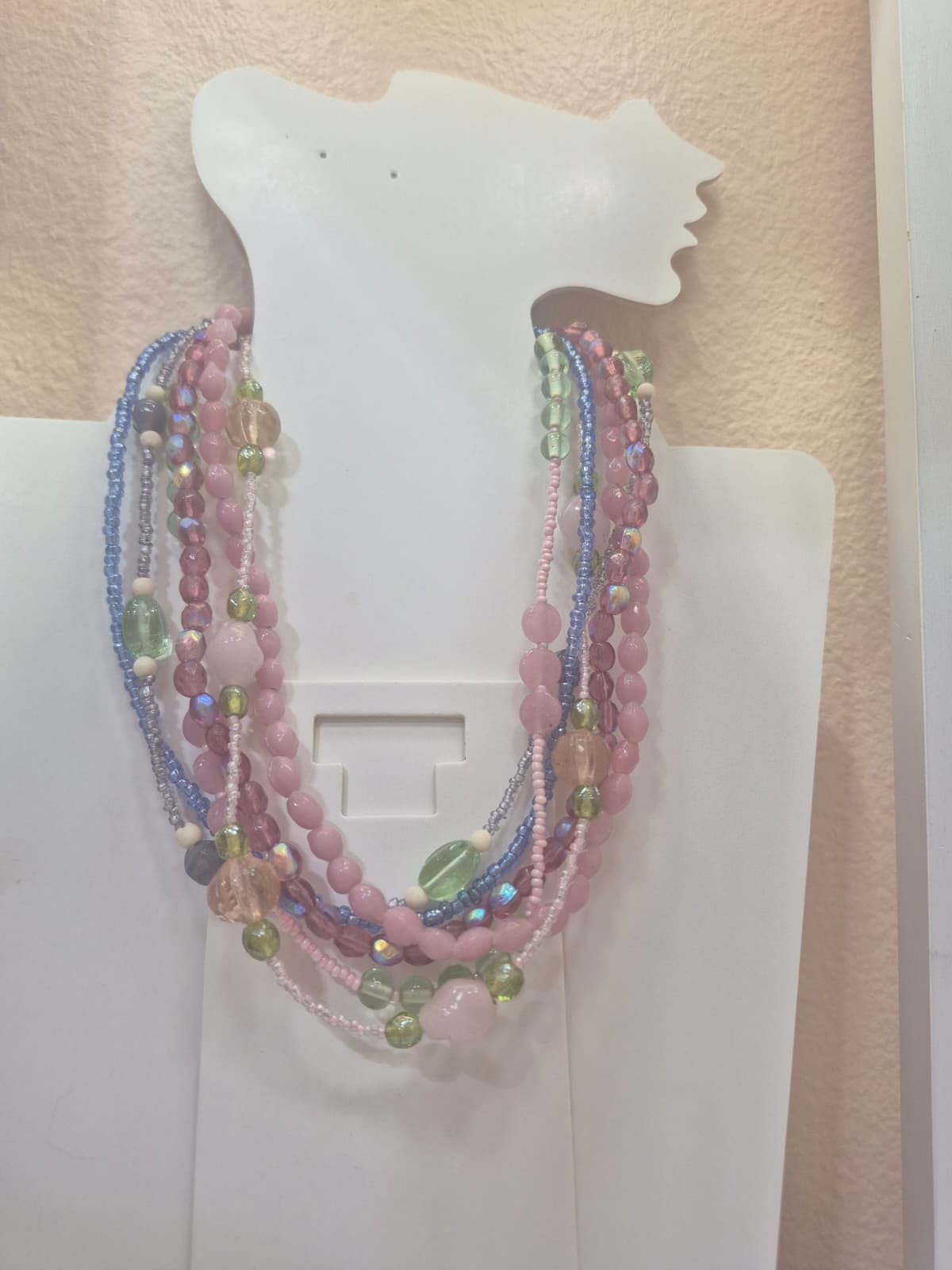 Multi-strand layered beaded statement necklace designed in a pastel color palett