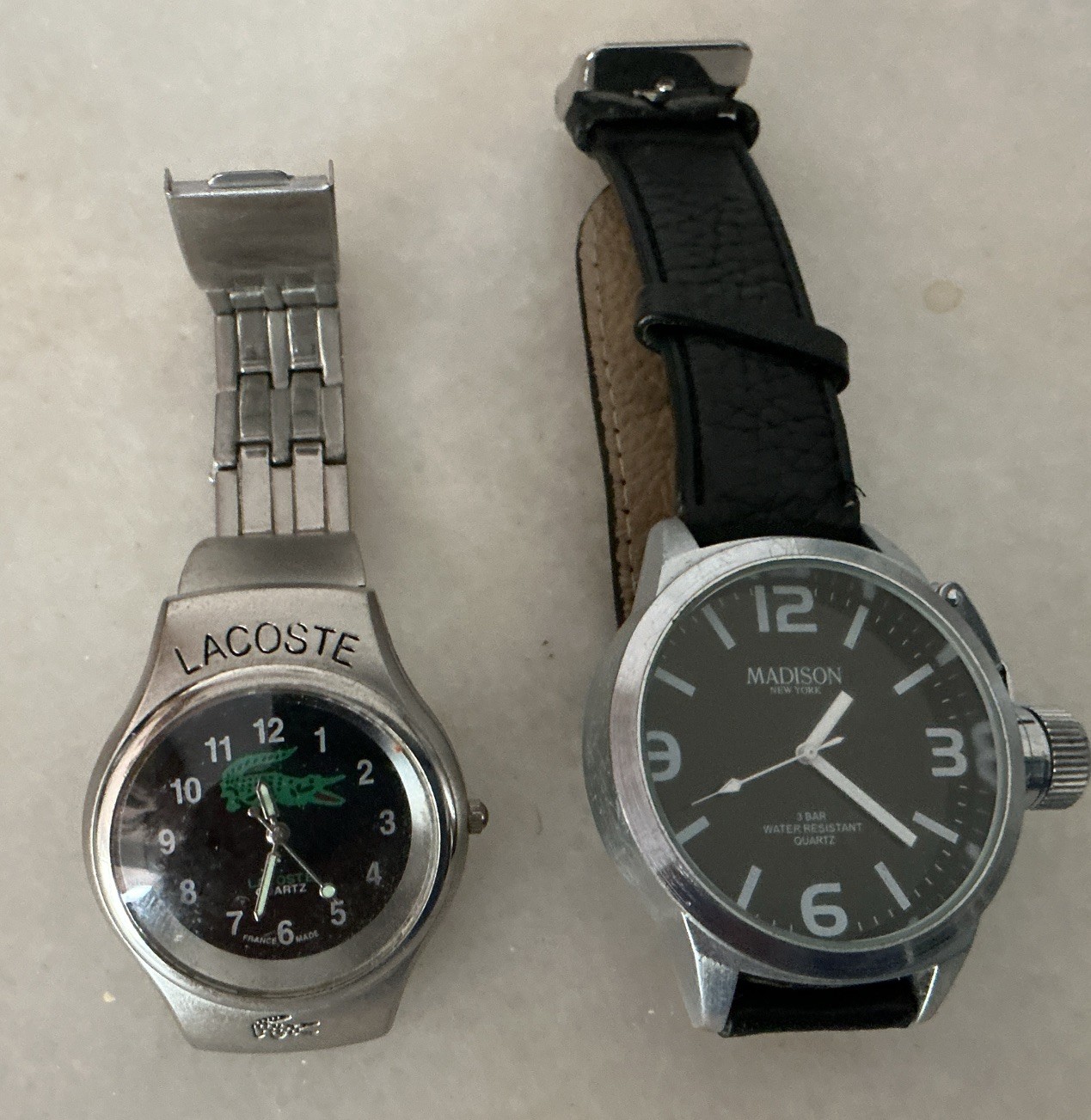 2 quartz watches needing a battery. 1) Lacoste . Good condition. 2) ￼Madison