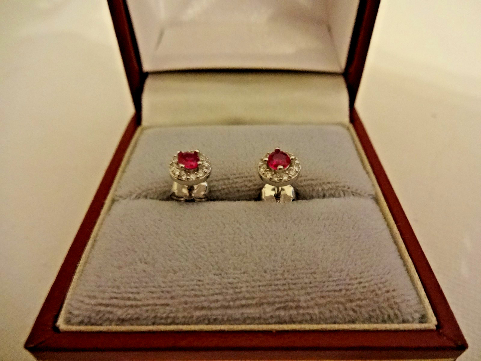 Created Ruby and diamond halo stud earrings in sterling silver