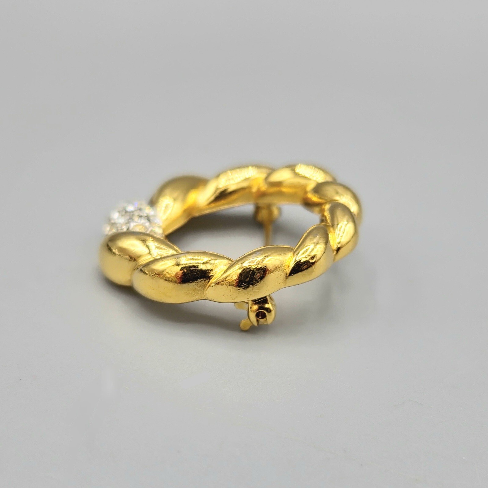 Crown Trifari Polished Gold Tone Crystal Pave Open Circle Twist Brooch