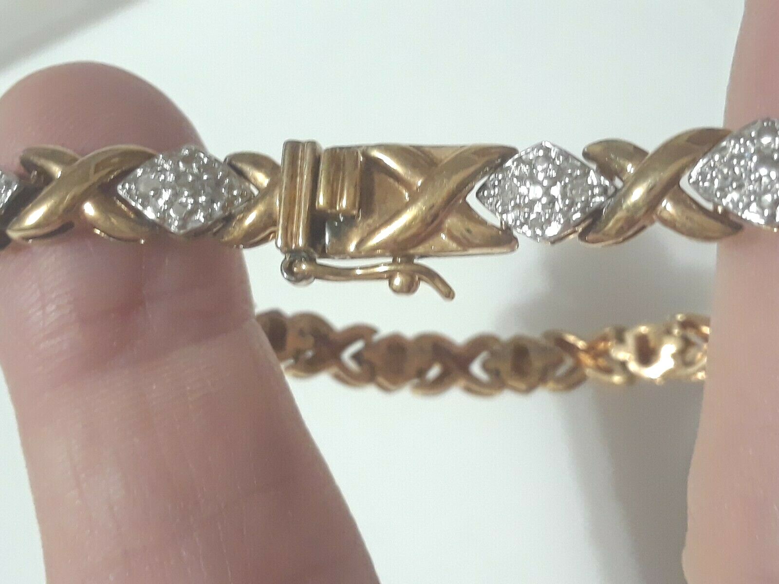 Gold tone bracelet with clear stones and safety lock clasp. 7″ long. Beautiful!