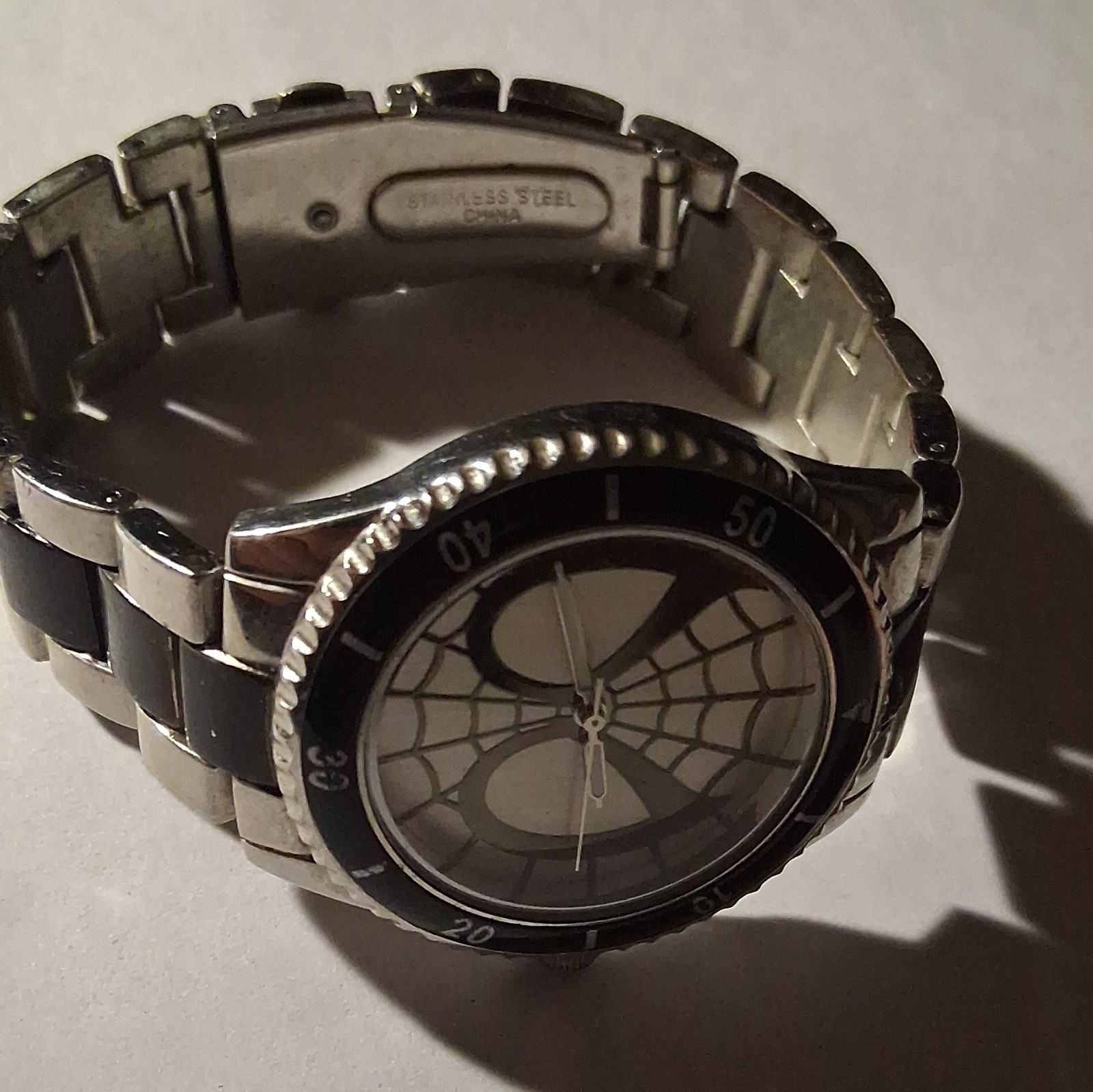 Marvel Men’s Analog Wristwatch Spiderweb Dial Black Fixed Bezel Silver Bracelet