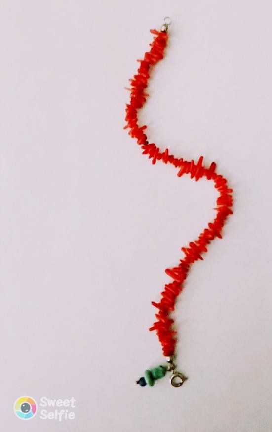 Coral bracelet with a silver clasp closure and a turquoise charm!