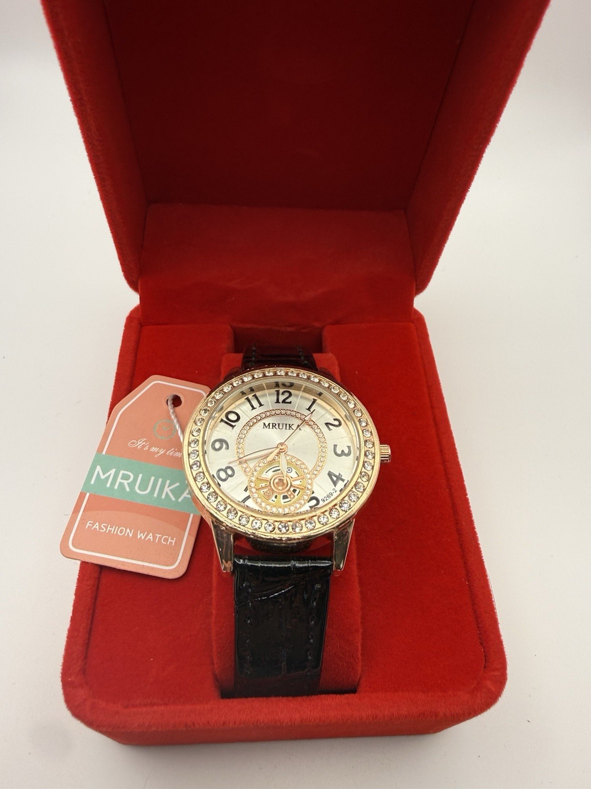 MRUIKA Fashion Watch Gold Tone Skeleton Style Crystal Bezel Black Strap New