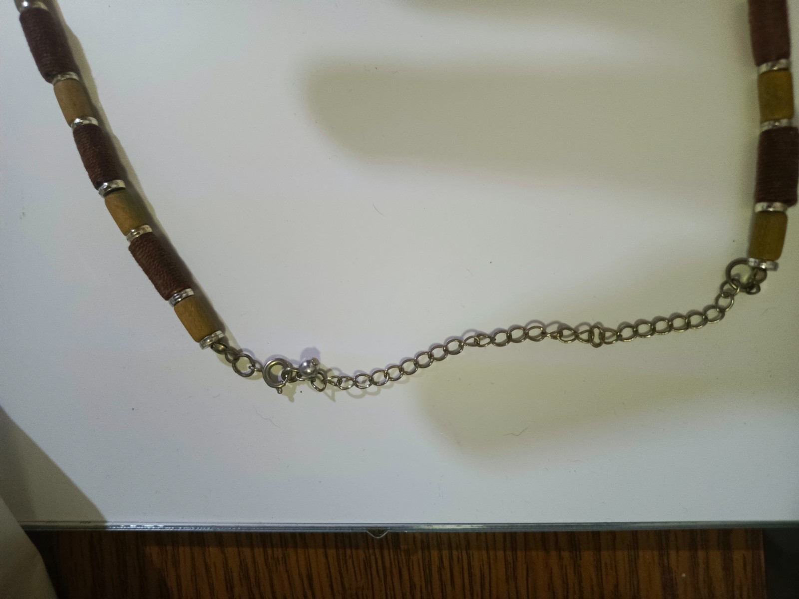 necklace features Polaris barrels in brown and beige separated by small gold-col