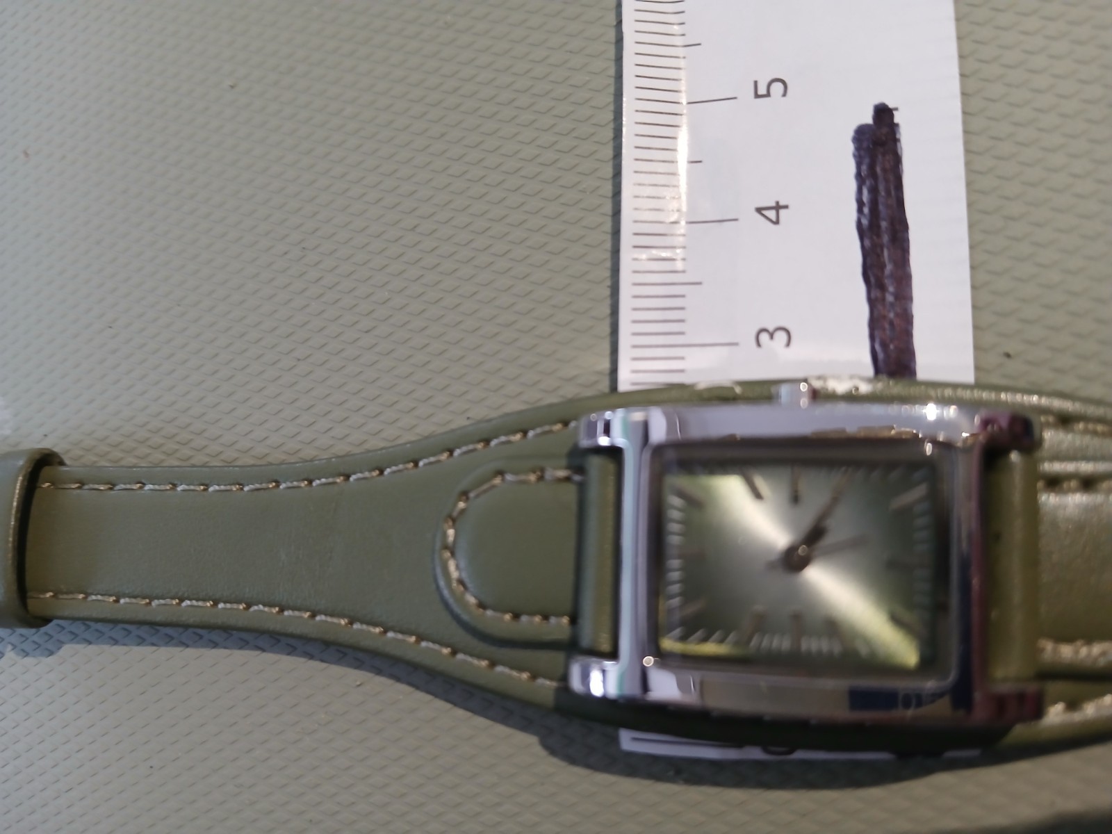 Ladies silver wathch with green face and one piece strap, new battery