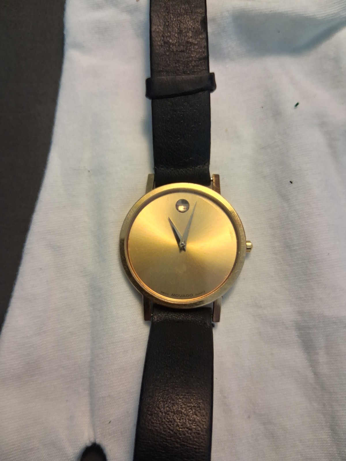 Movado Museum Wrist Watch for Men, gold face, black leather band, NEW Battery