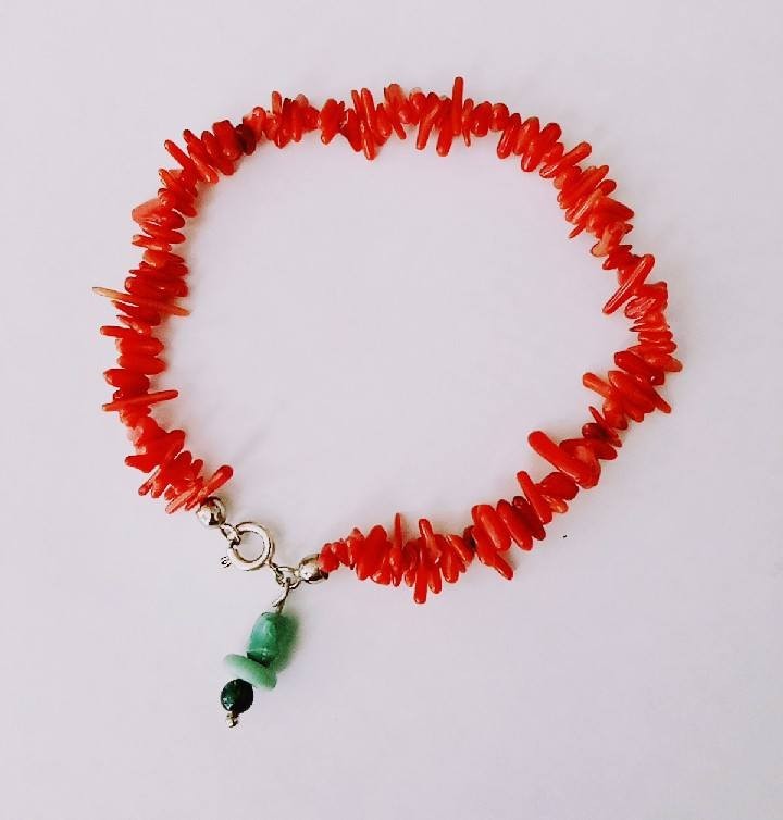 Coral bracelet with a silver clasp closure and a turquoise charm!