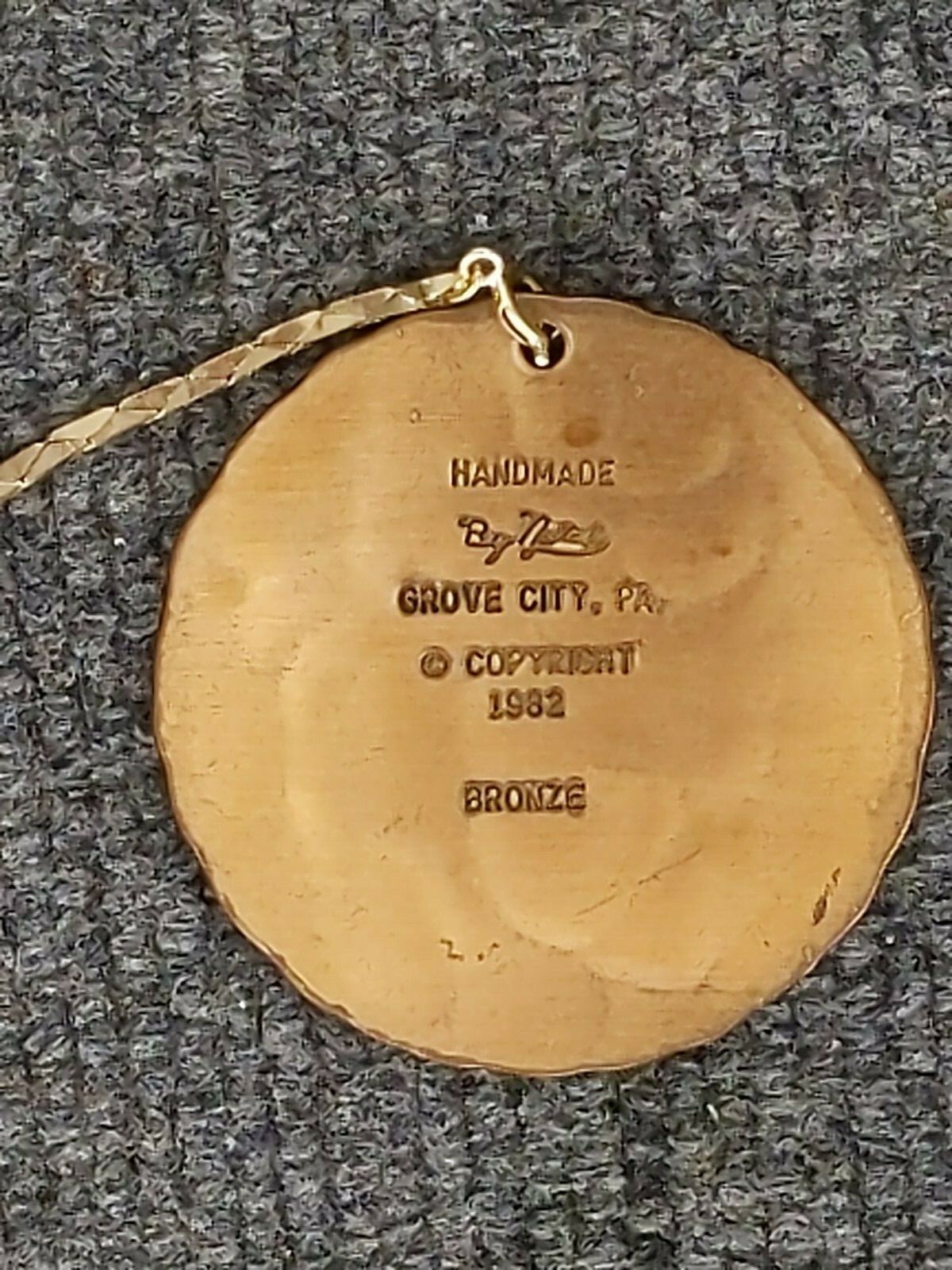 Natale winter scene medallion pendant 2 1/8 in d; dated 1982 handmade bronze