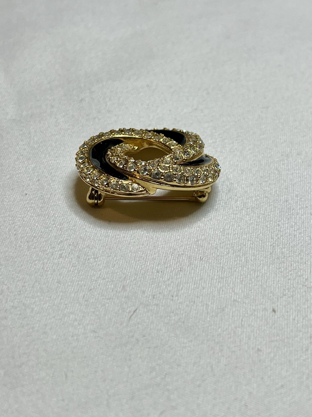Signed Swarovski Gold Tone Clear Crystal Black Enamel Love Knot Brooch Pin