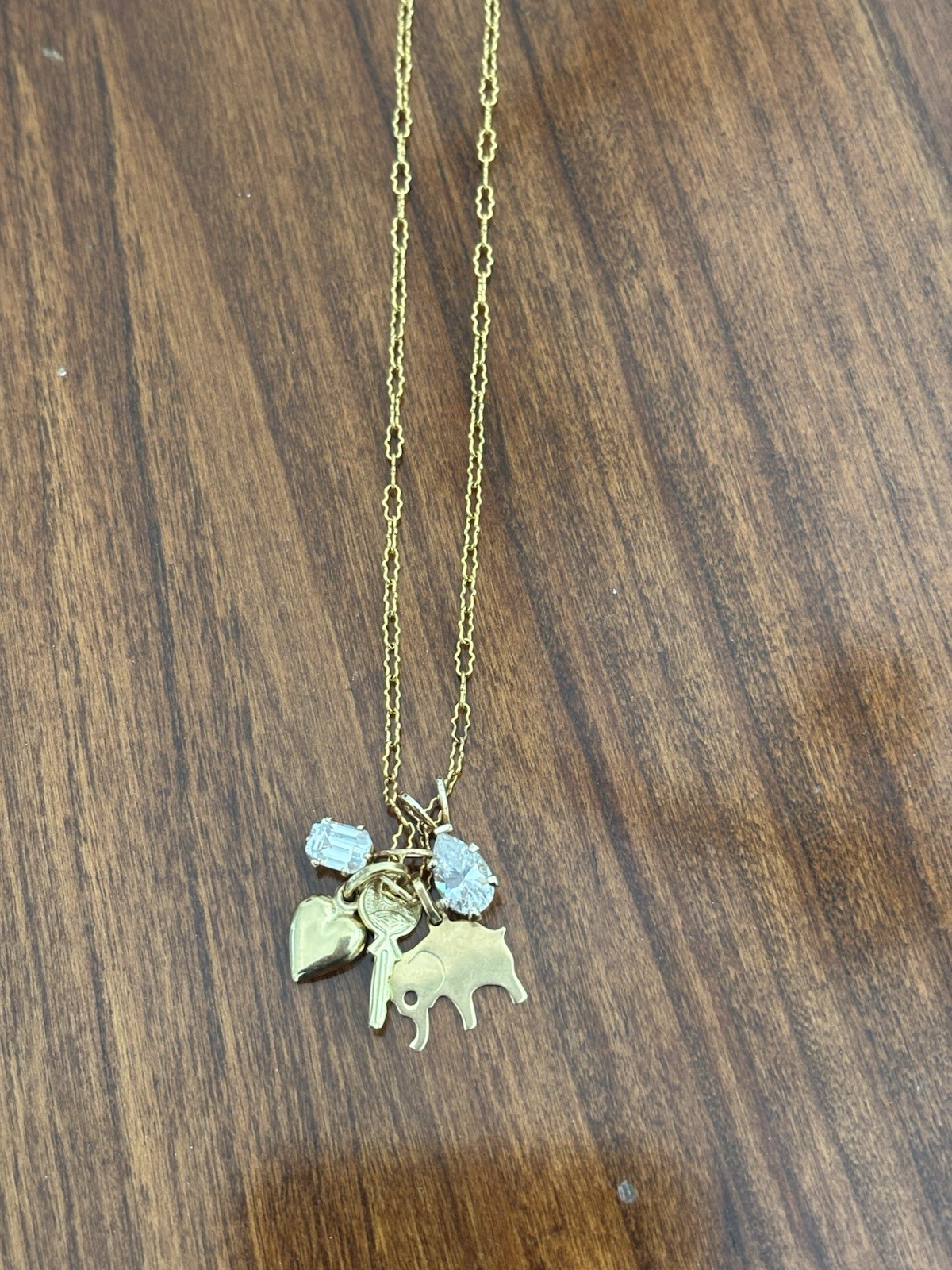 Monet Gold Tone Charm Necklace With Heart, Elephant, Key and Clear Stone Charms