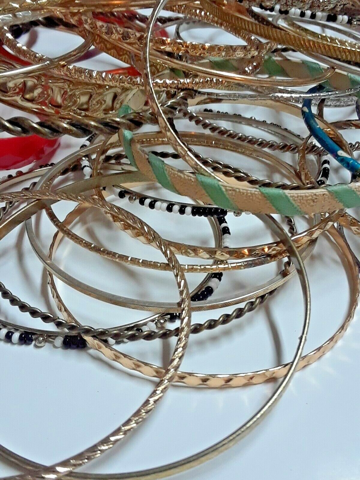 Bangle bracelets. gold tone silver tone, metal, plastic, with patterns. Lot