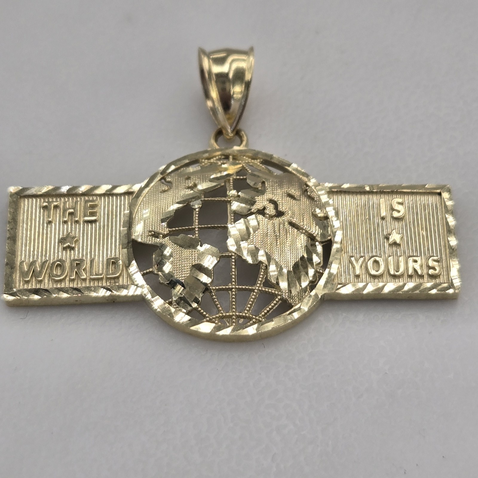 10k Yellow Gold The World Is Yours pendant
