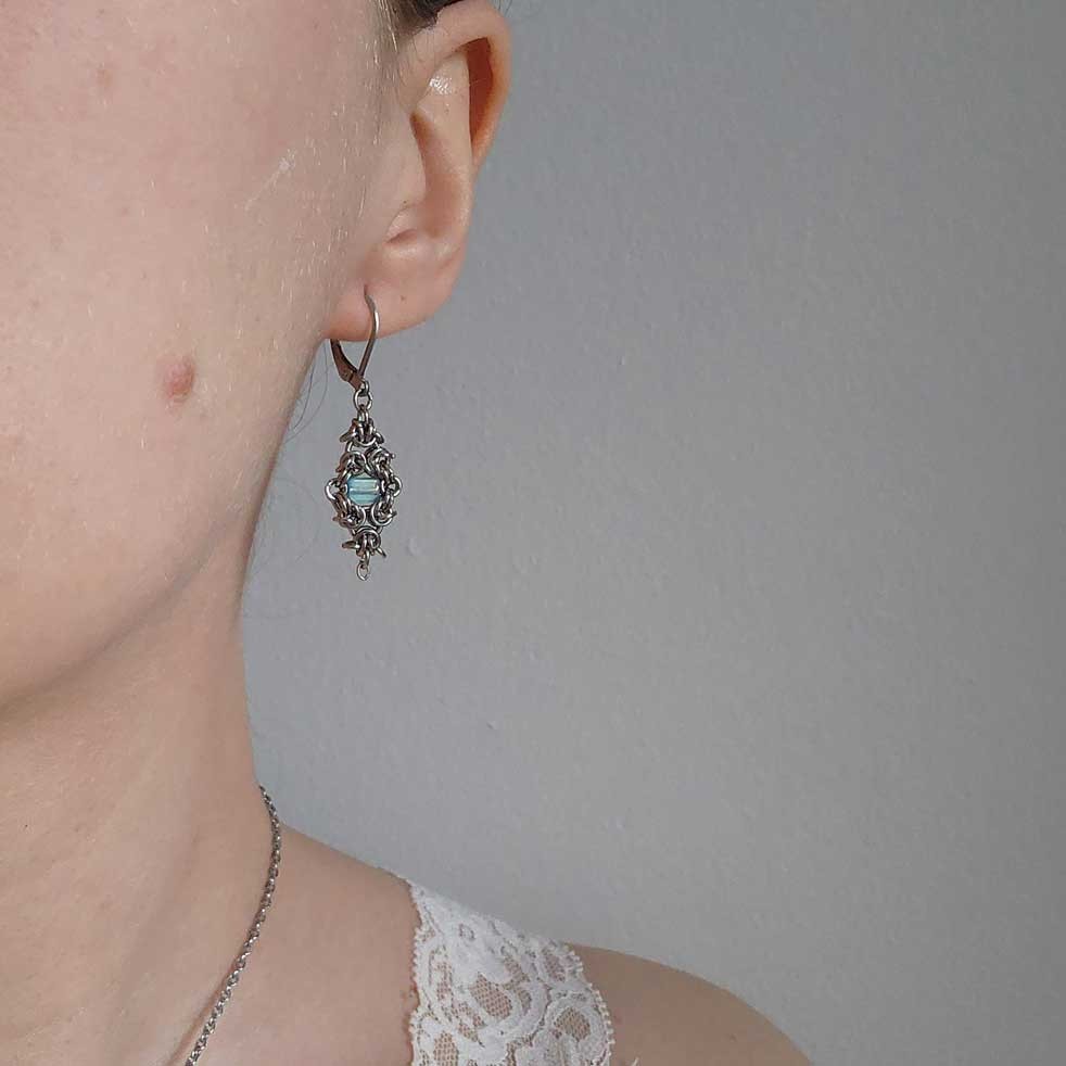 Silver and teal dangly lever back earrings made of stainless steel