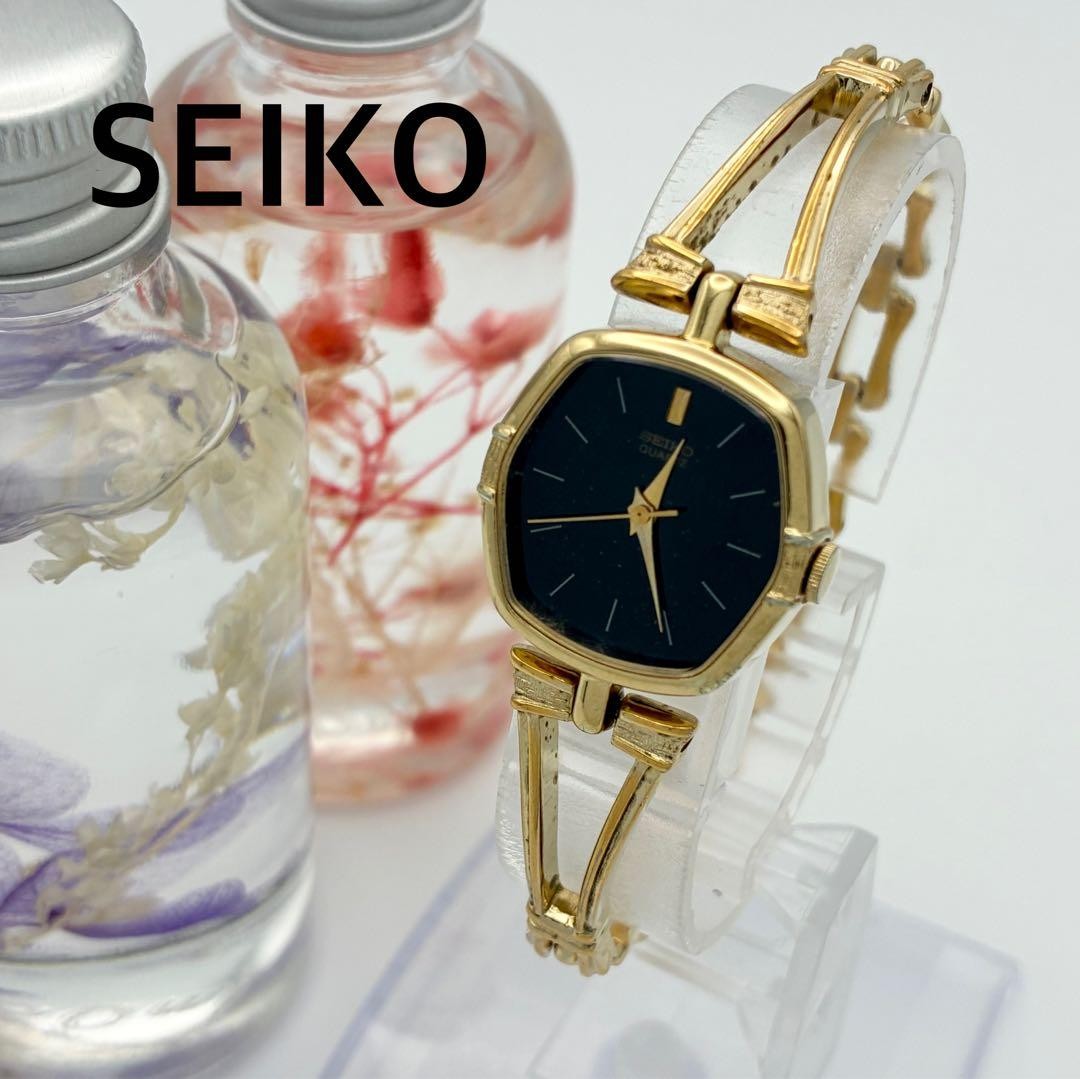 Working SEIKO wristwatch, gold and black, with new battery (A72)