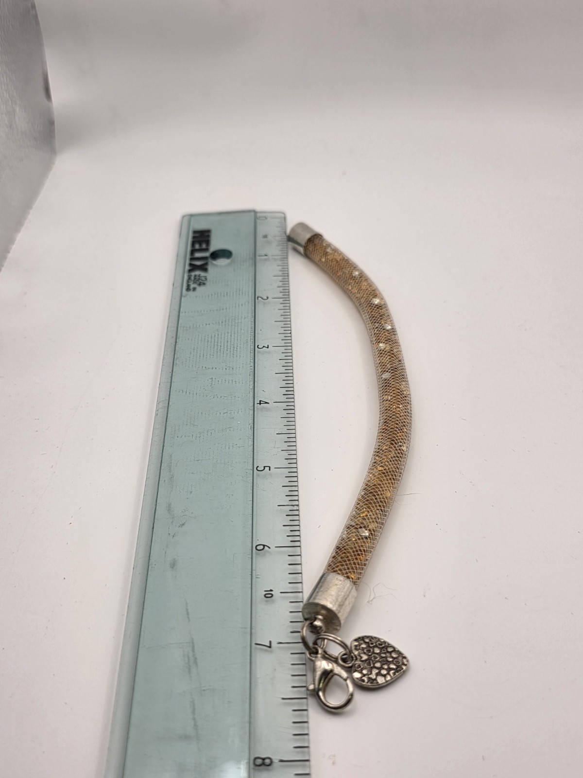 Gold Tone Tubular Mesh Bangle With Crystals And Heart Charm