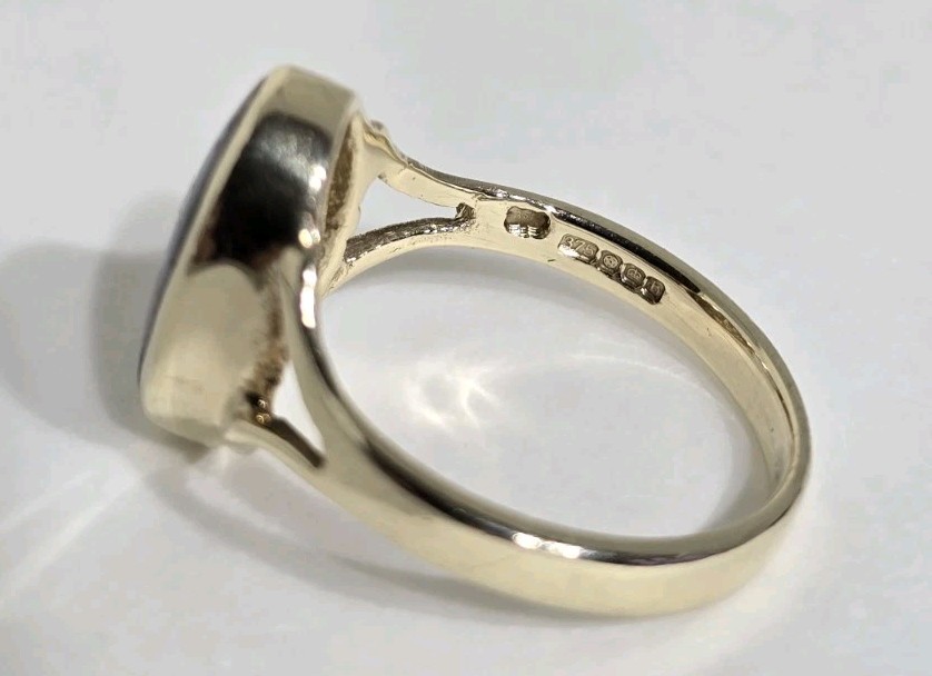 9ct Yellow gold open work ring. Collet set with an oval Blue John Cabochon.