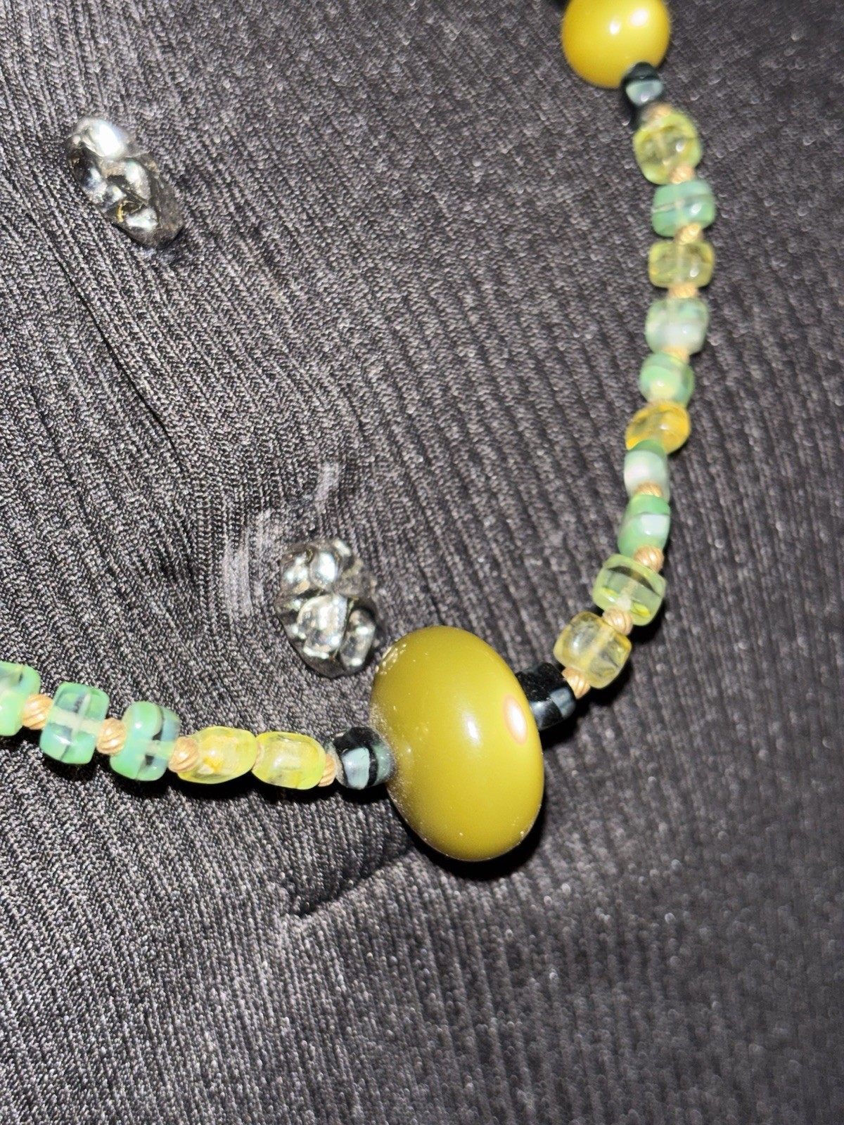 multi-stone beaded necklace featuring various green and yellow beads