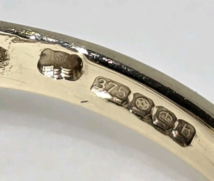 9ct Yellow gold open work ring. Collet set with an oval Blue John Cabochon.