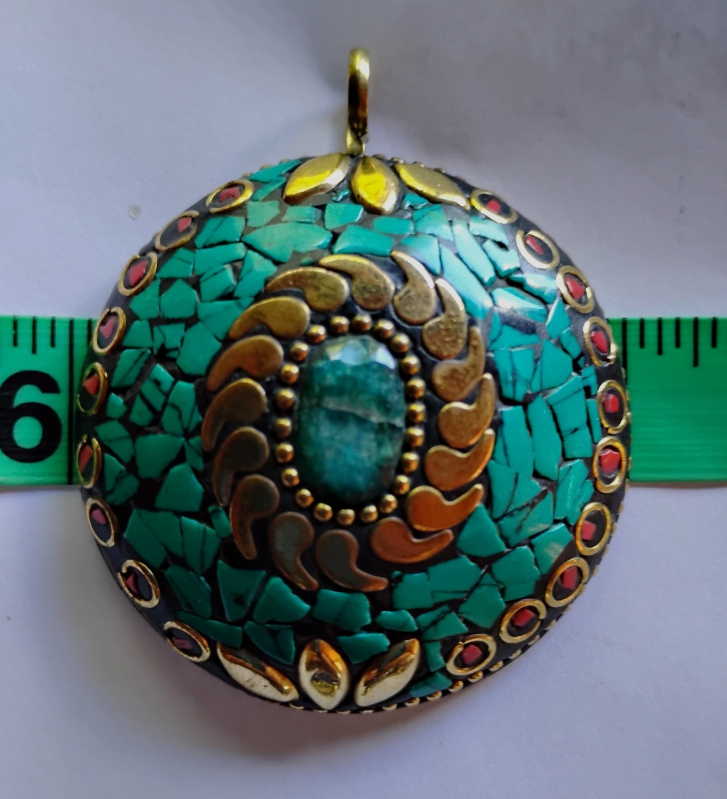 2 inch round brass pendant with turquoise, emerald center stone and red stone ac