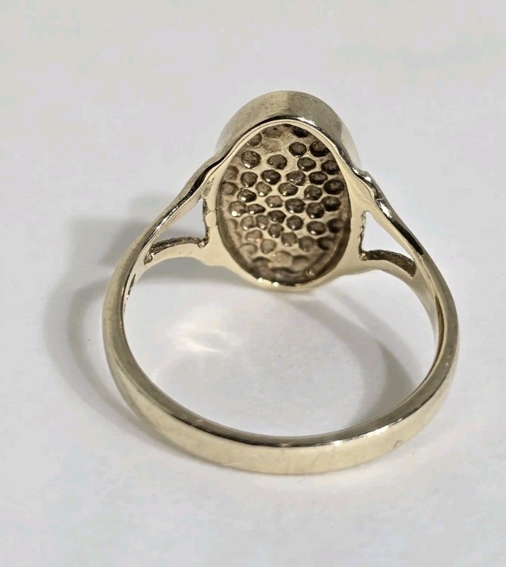 9ct Yellow gold open work ring. Collet set with an oval Blue John Cabochon.