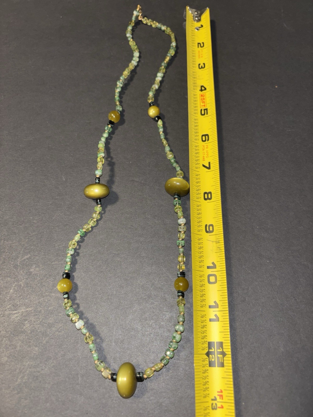 multi-stone beaded necklace featuring various green and yellow beads