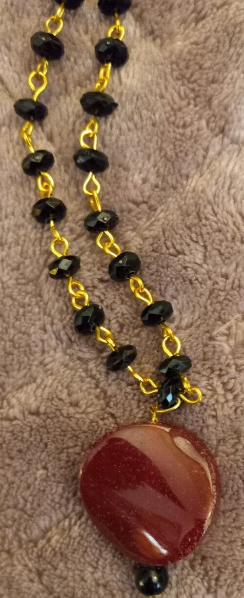 Gold And Black Necklace With A Red Glass Stone Pendant 22″