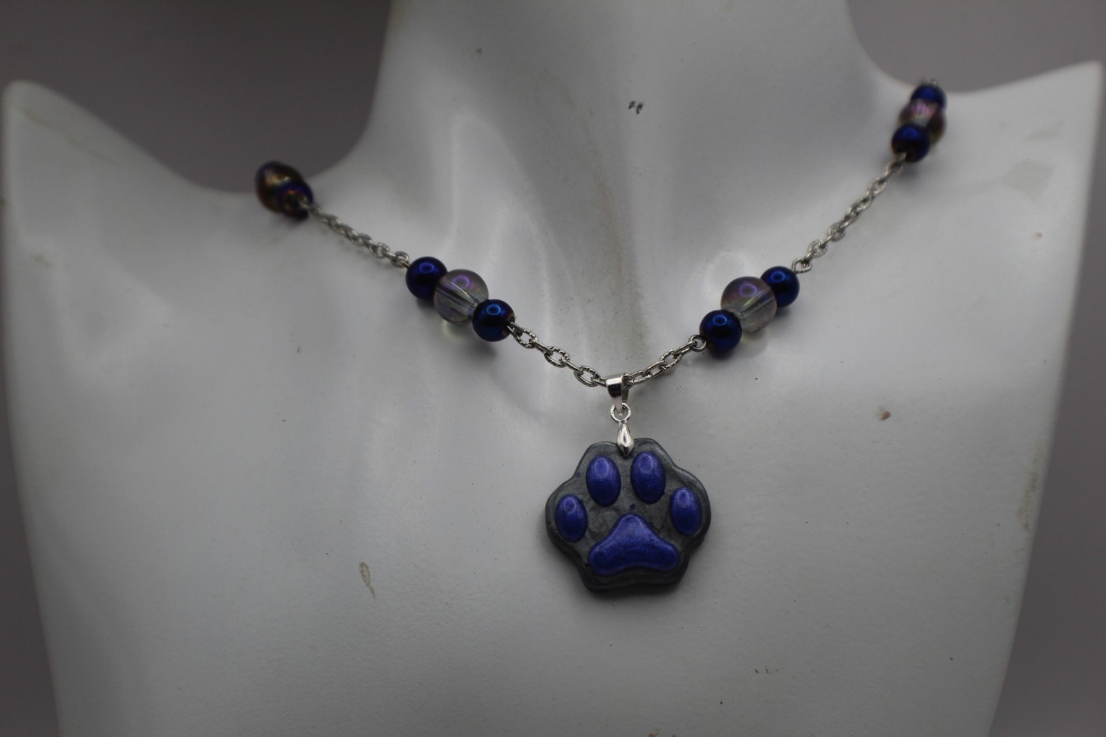Cute Purple Paw Print Resin Pendant On A Beard Chain Necklace.