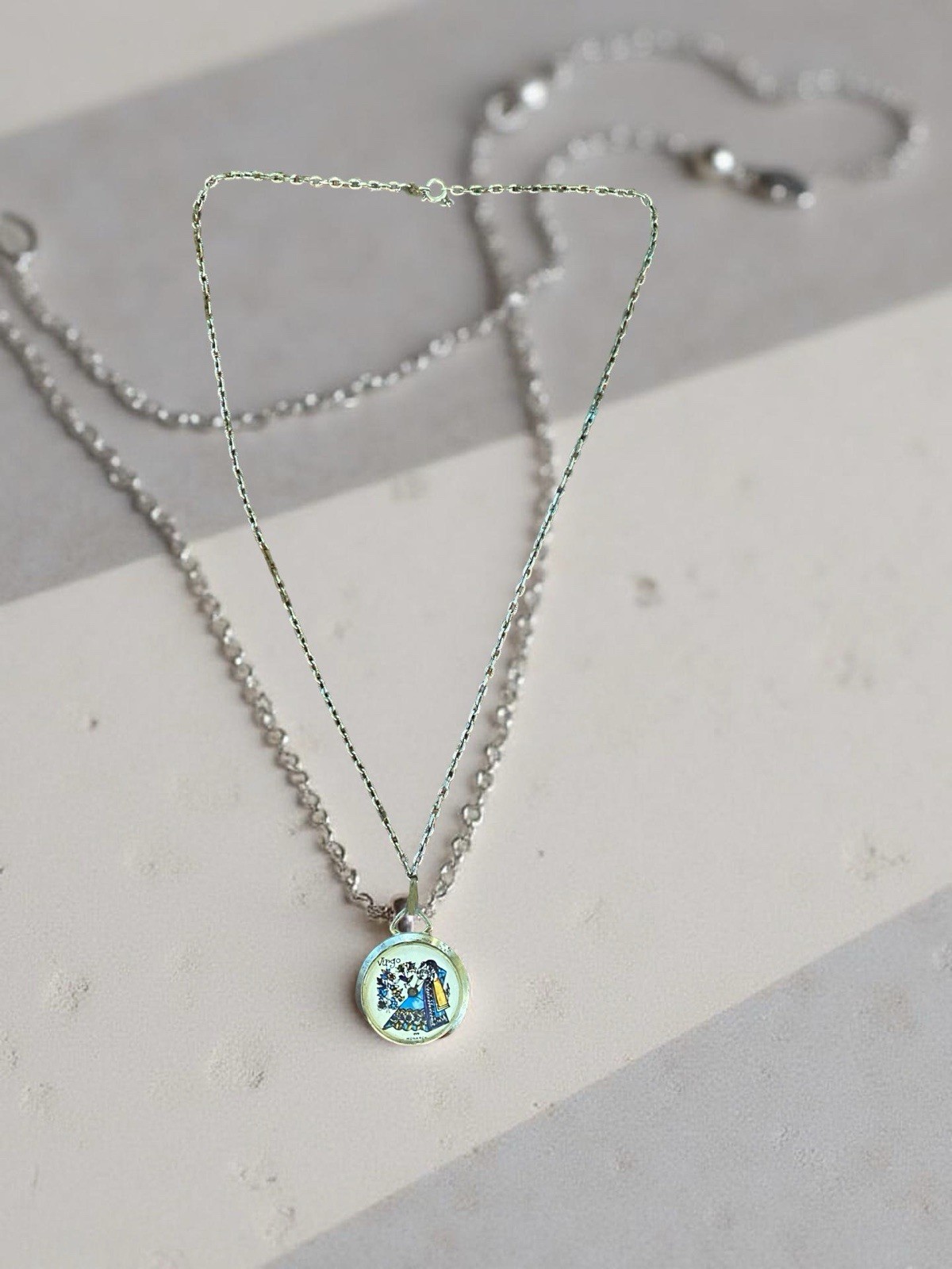 Brass pendant with Virgo zodiac sign illustration