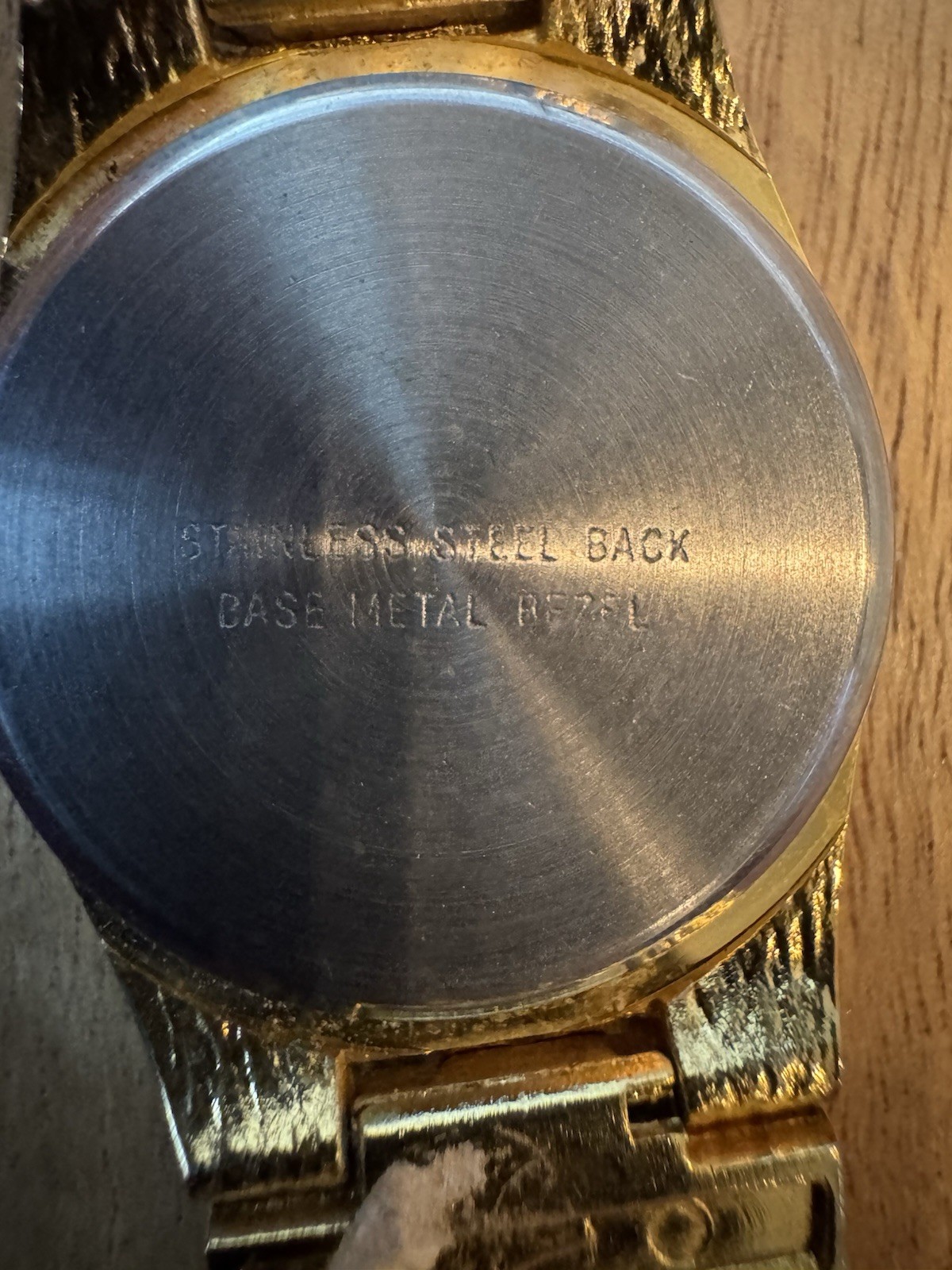 Analog wristwatch silver metal band brushed case black dial video game theme