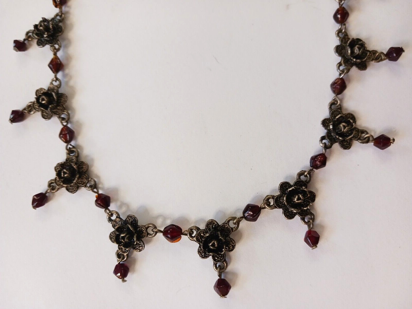 Beautiful silver tone necklace with flowers and red stones. hook clasp. Vintage