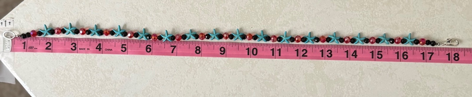 Handmade turquoise-colored starfish beads and red and black glass beads necklace