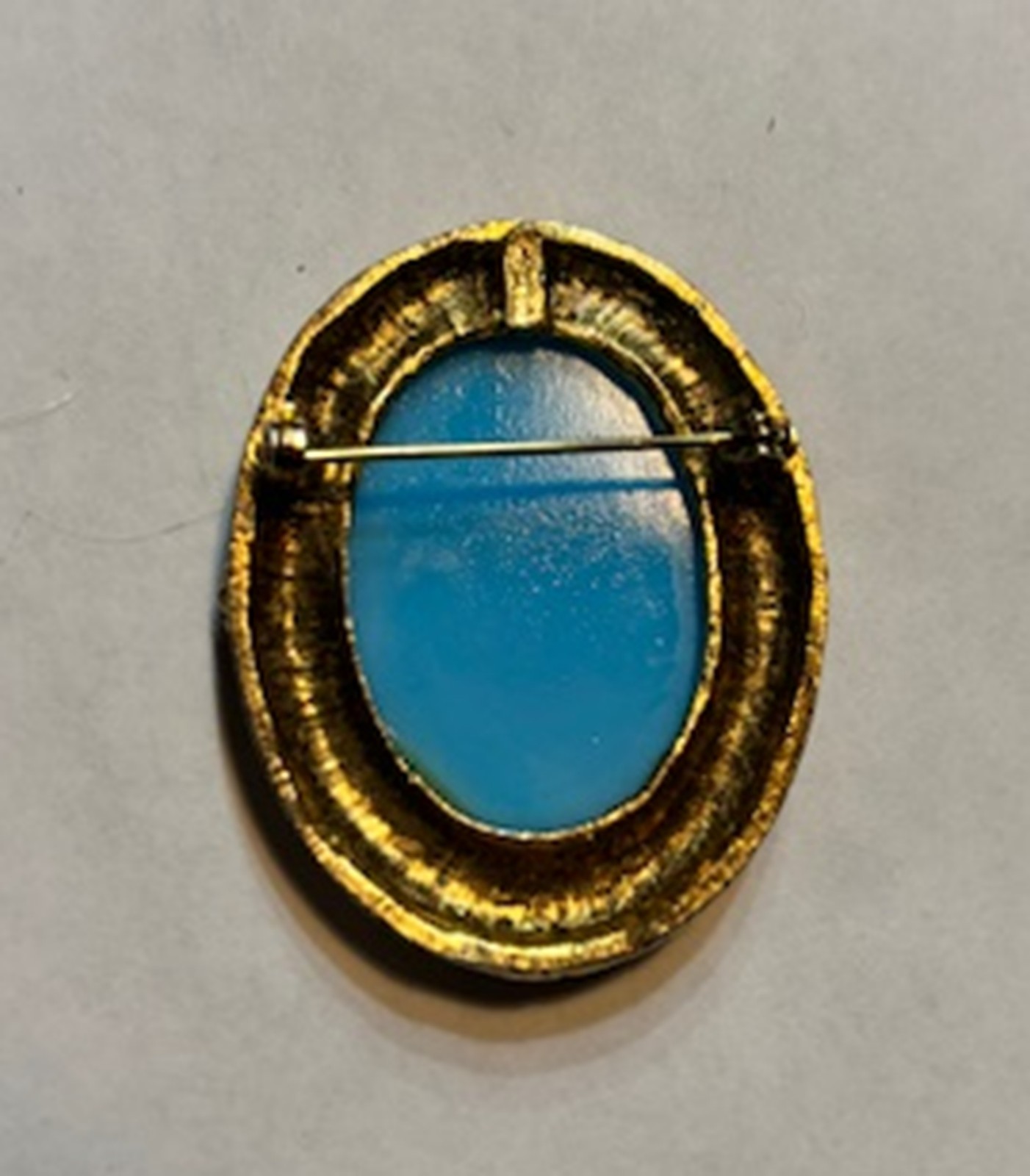 Antique Blue Cameo Brooch with classical figure in an ornate gold-tone frame