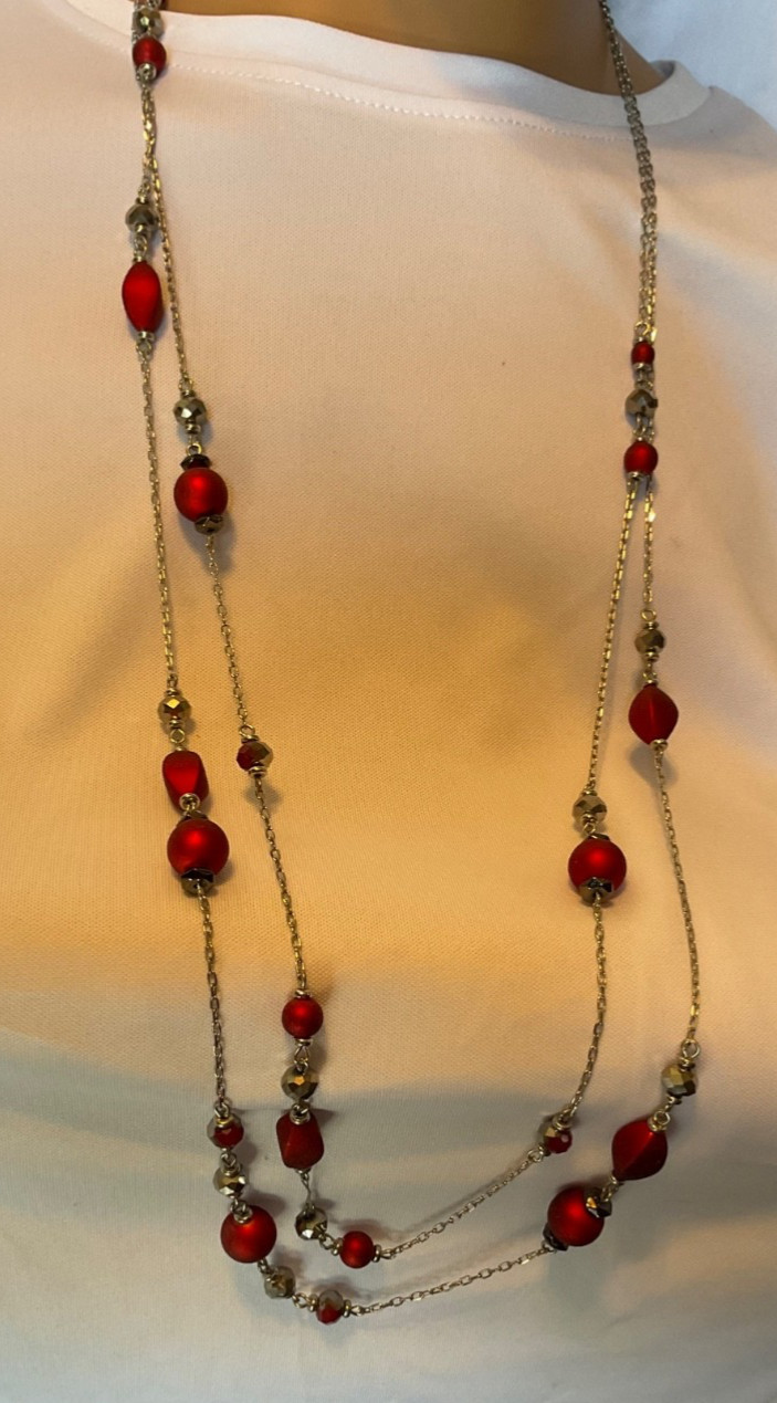 Marked “ruby red”. Necklace features red beads with glassy beads on silver chn