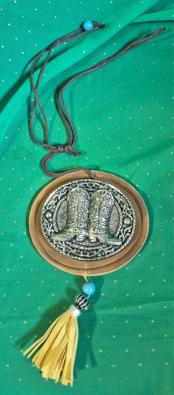 Western-style hanging charm features a decorative buckle with cowboy boots atta