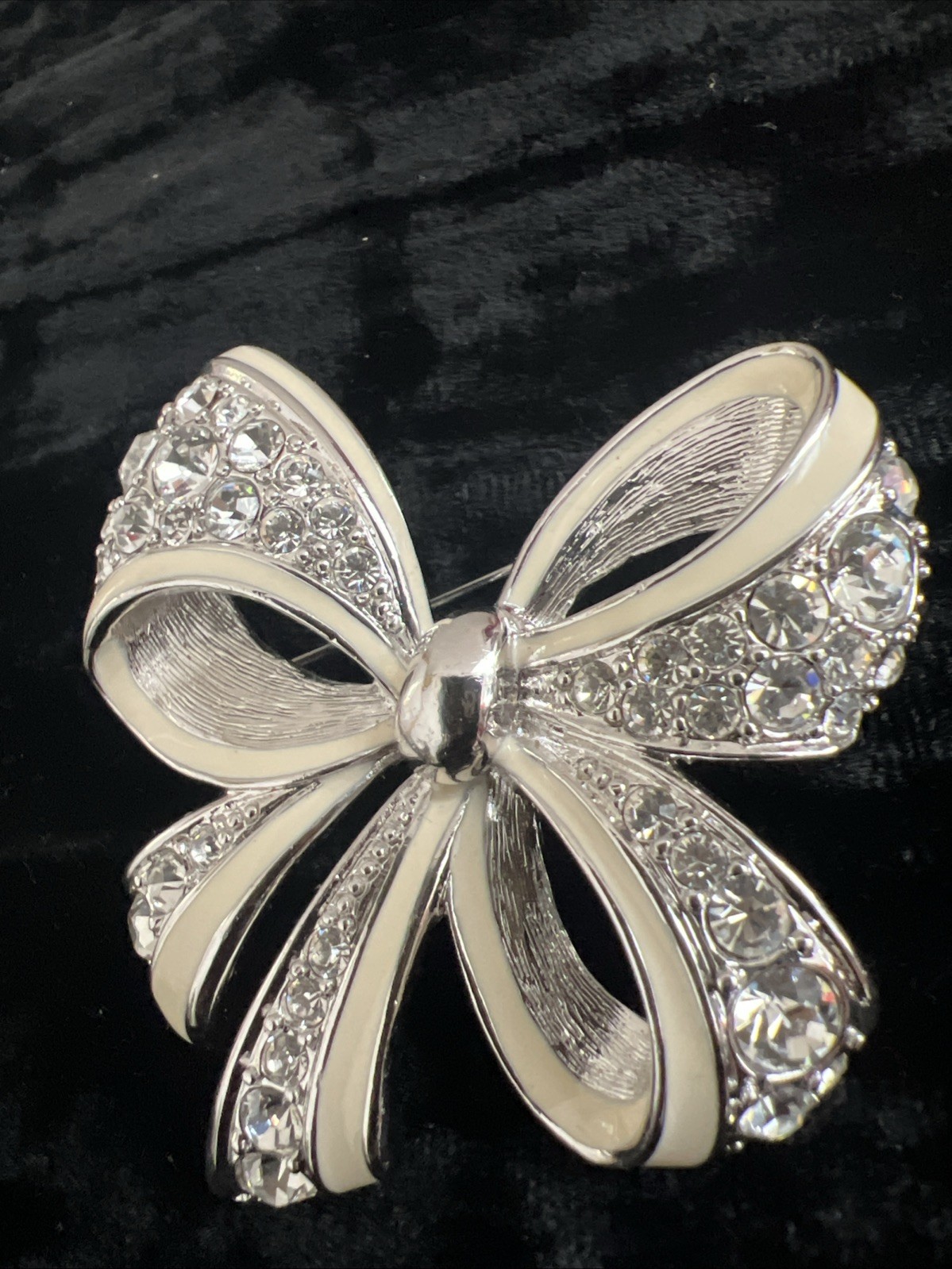 item is a Nolan Miller Shining Spirit rhinestone bow brooch from the Glamour CO.