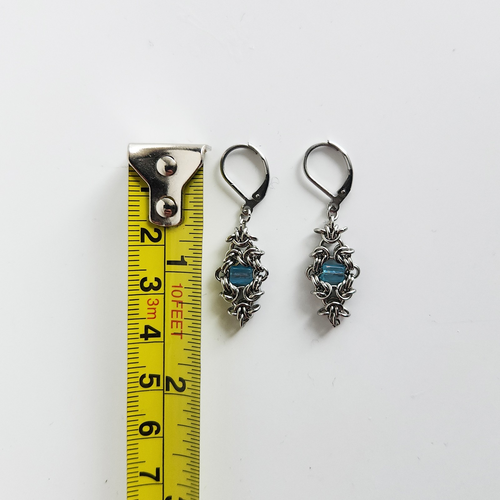 Silver and teal dangly lever back earrings made of stainless steel
