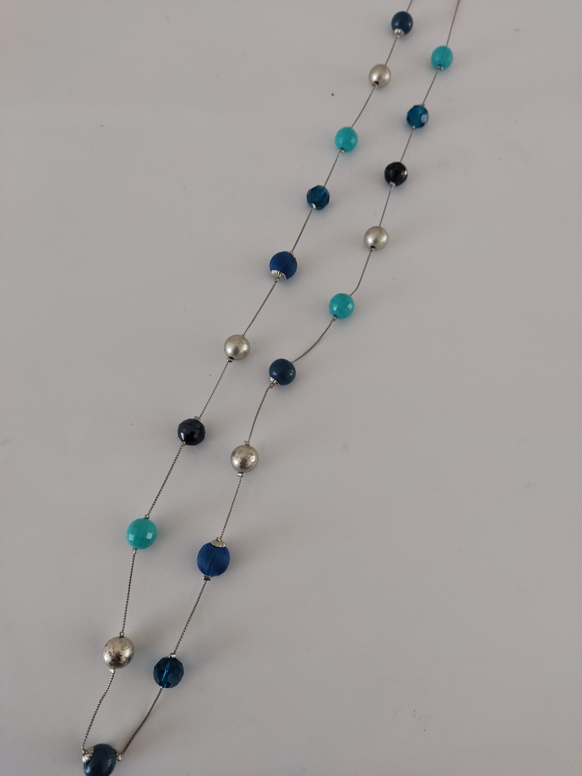 Accessorize long mixed bead blue Turquoise Navy necklace.