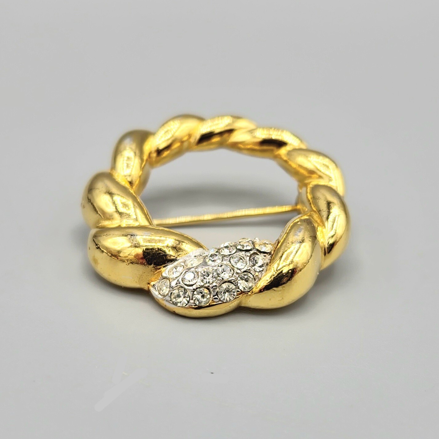 Crown Trifari Polished Gold Tone Crystal Pave Open Circle Twist Brooch