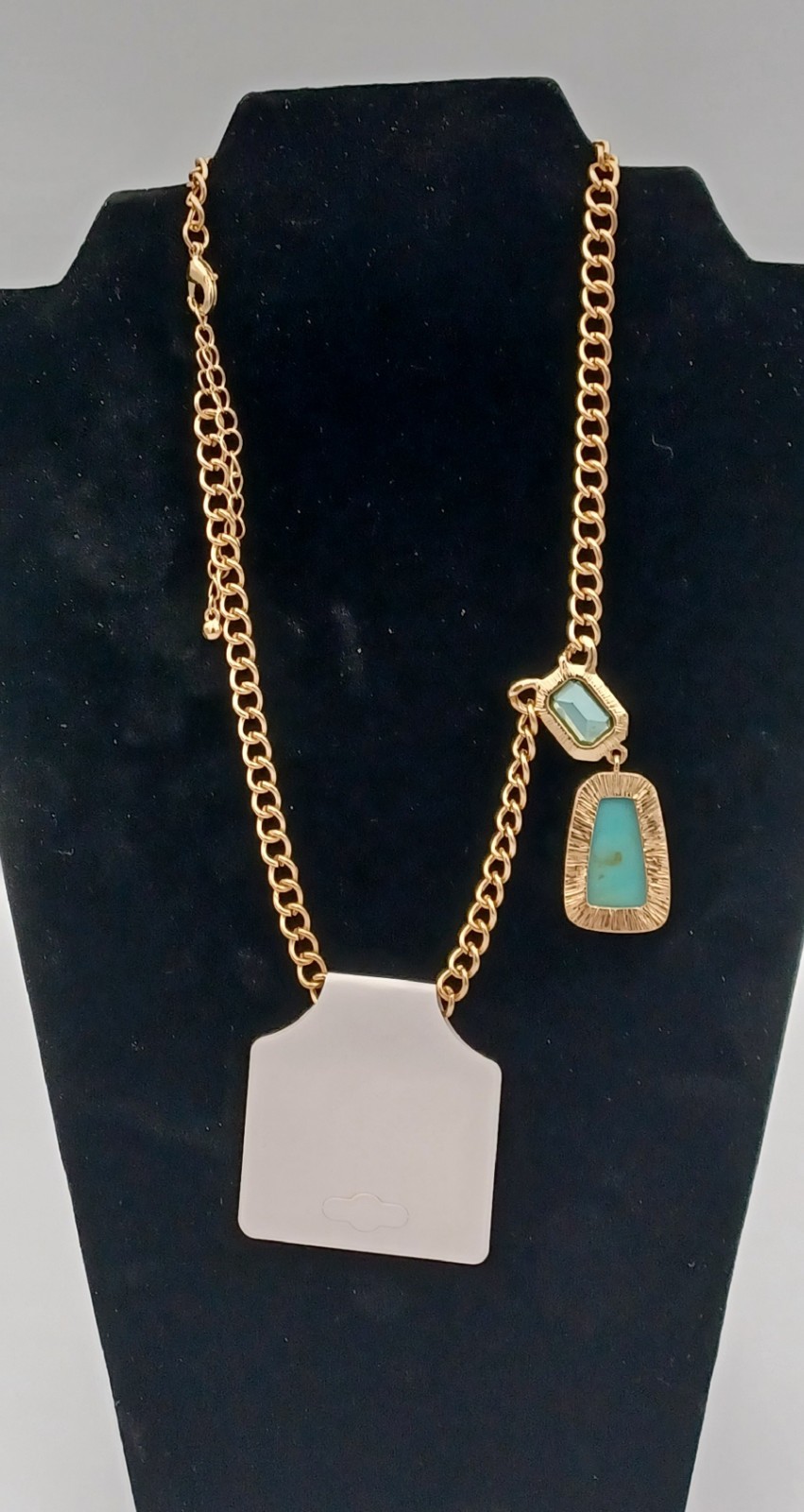 Calvin Klein gold tone necklace featuring two elegant stones in light blue and g