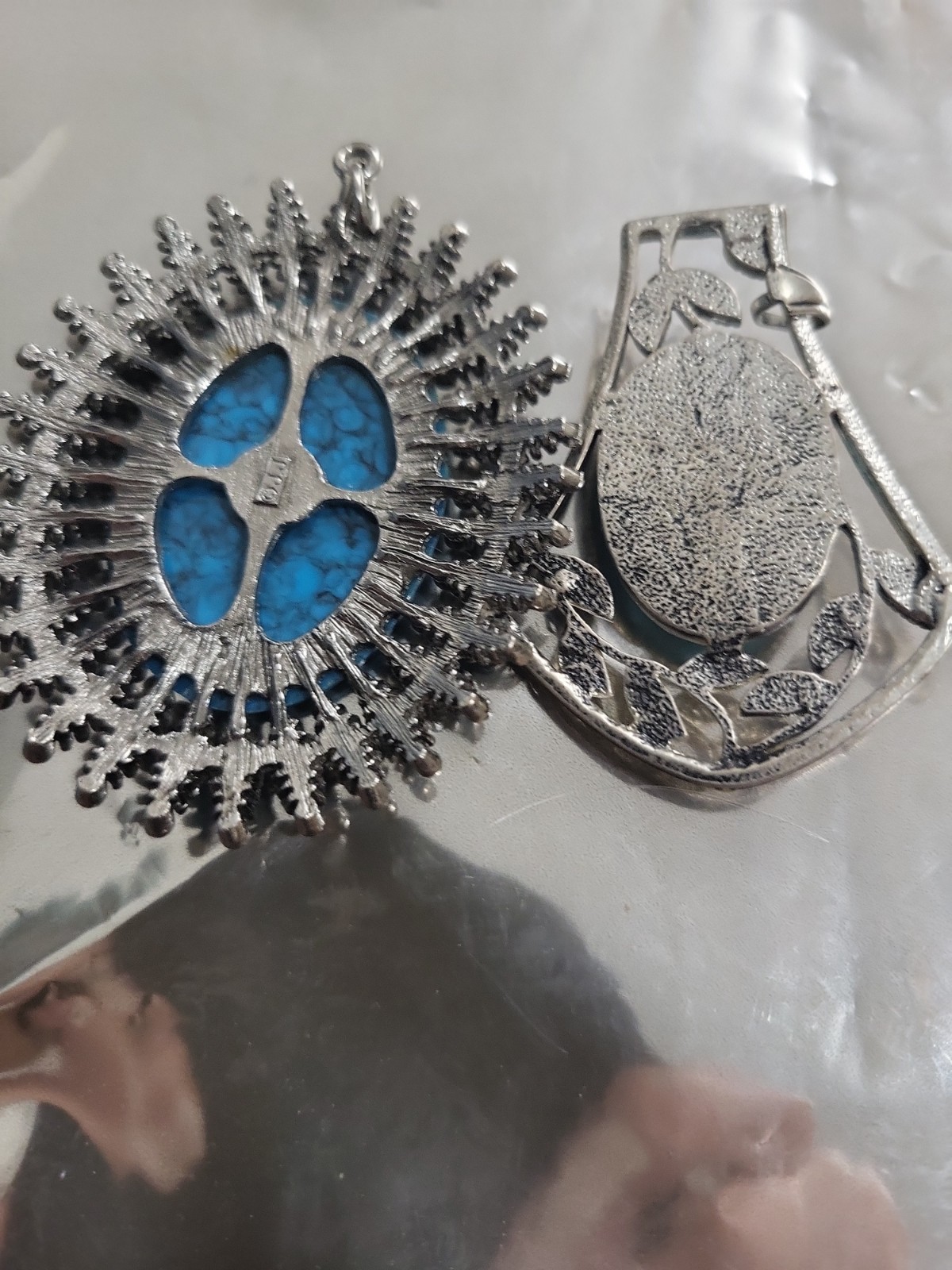 2 Faux Turquoise silvertone pendants. lg one is marked JJ both great pieces