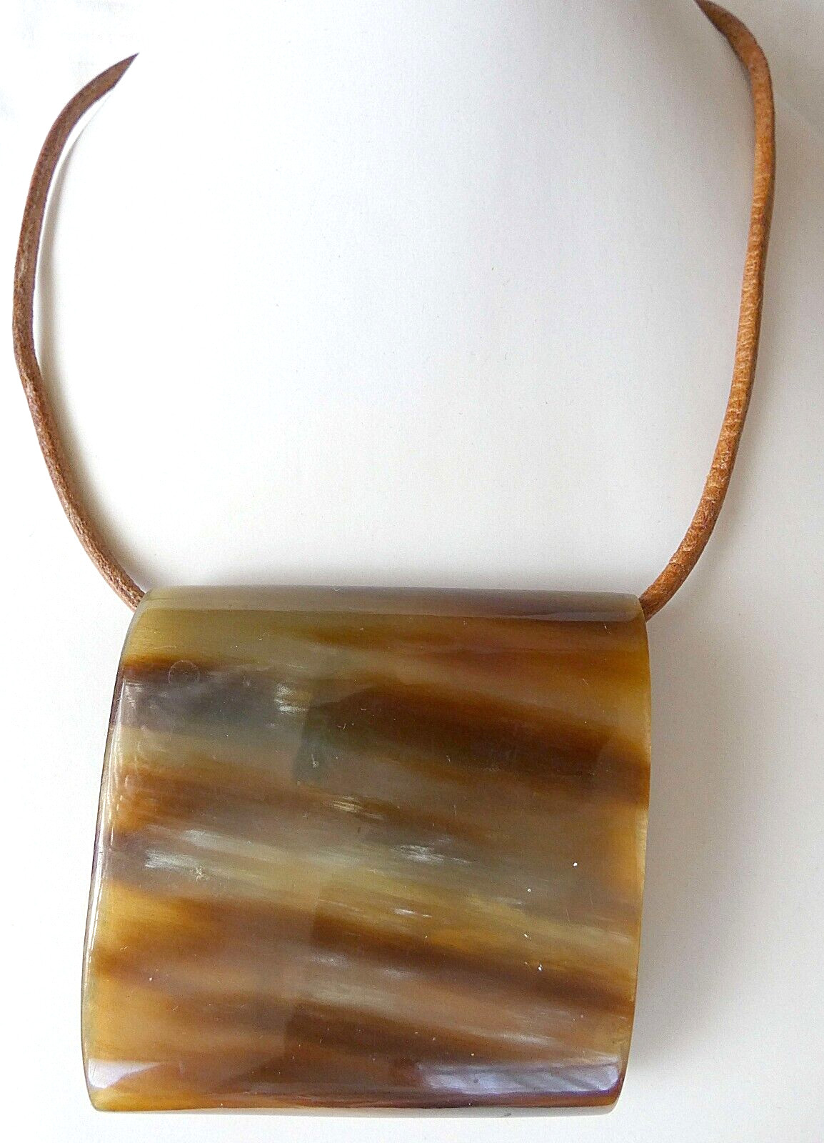 Antique horn necklace with leather cord. Size of pendant: 6.8 x 6.6 cm.